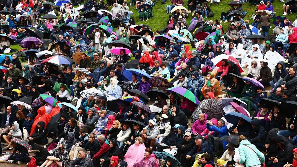 Supporters brave the elements during day three at Wimbledon. Photograph:    Jordan Mansfield/Getty Images
