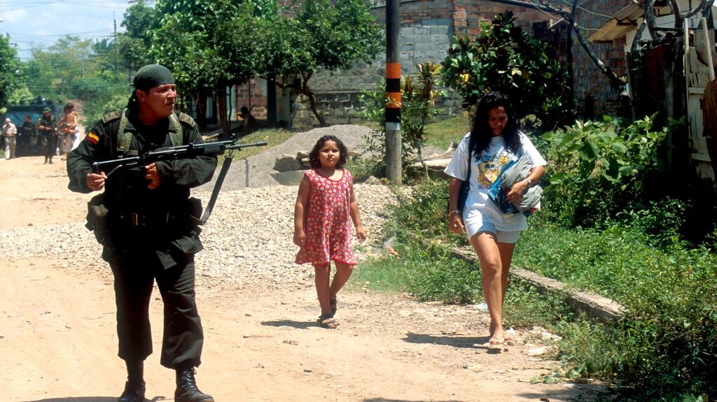 A federal police officer patrols a Farc-controlled barrio of Barrancabermeja, Colombia, in 2000. Photograph: Robert Nickelsberg/Liaison