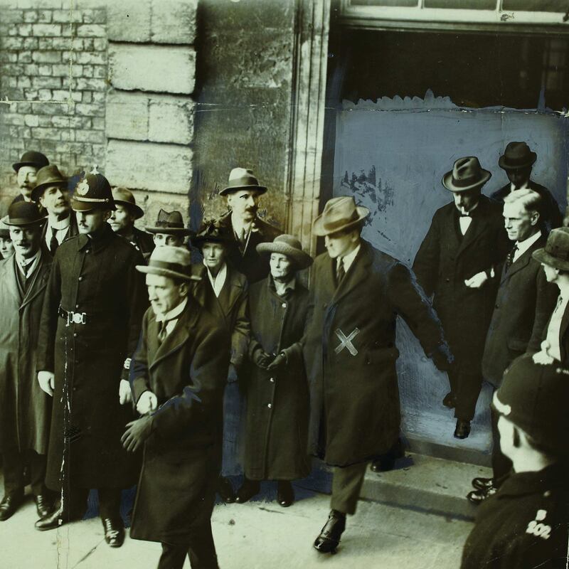 Kevin O’Higgins, Michael Collins (marked with an ‘x’) and Éamonn Duggan leaving Dublin Castle on January 16th 1922. Photograph: Joseph Cashman/National Library of Ireland