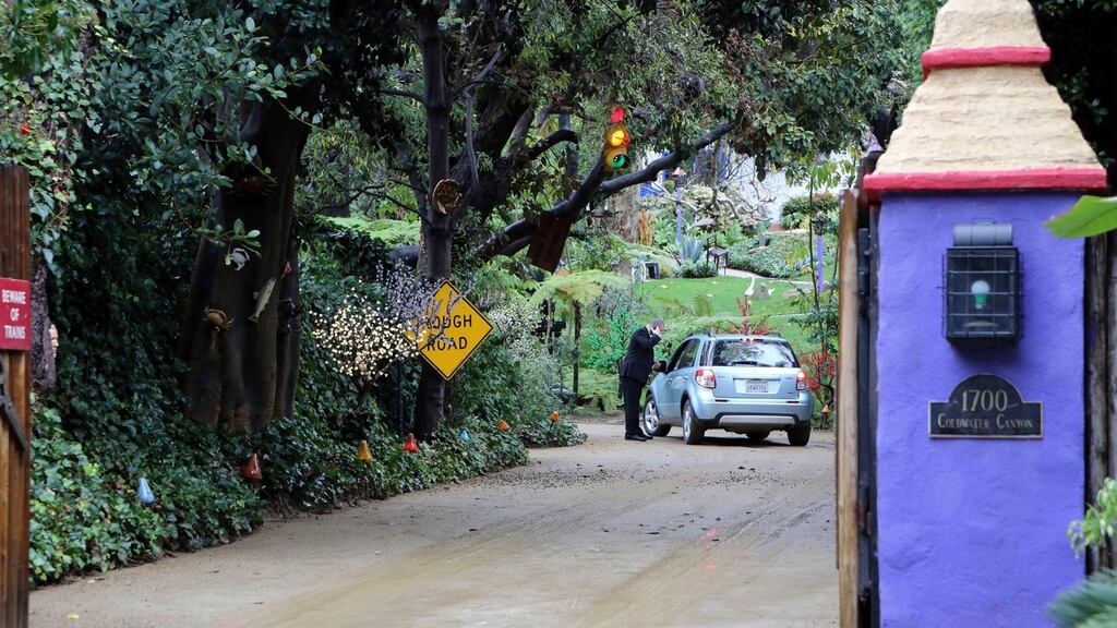 A security guard talks to a driver arriving at the homes of Debbie Reynolds and her daughter Carrie Fisher for a private memorial service in Los Angeles, California. Photograph: Reed Saxon/AP Photo