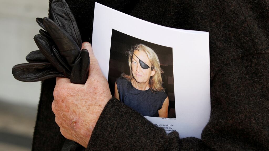 A man holds a sign honouring journalist Marie Colvin at a memorial service in London in May 2012. File photograph: Stefan Wermuth//Reuters