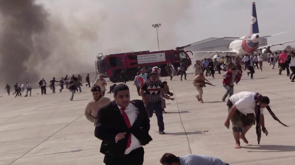 People run following an explosion at the airport in Aden, Yemen, shortly after a plane carrying the newly formed Cabinet landed. Photograph: AP Photo