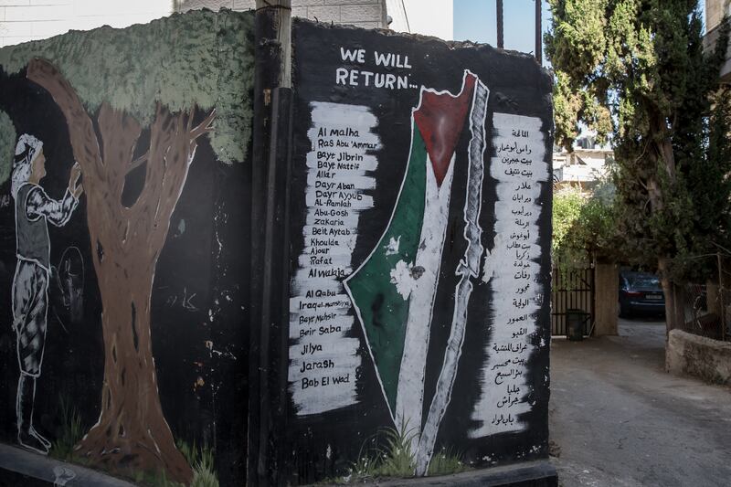 The names of villages from which the relatives of residents in Aida refugee camp were displaced are painted on a wall