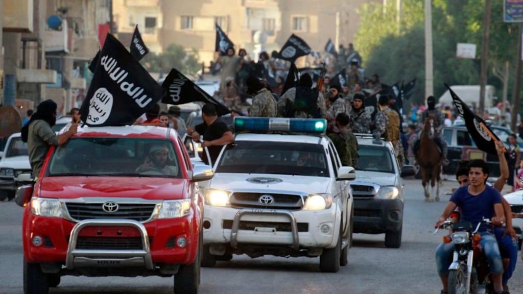 Isis fighters waving flags in a military parade along the streets of Syria’s northern Raqqa province. The jihadist group’s latest gains in Syria are more incremental than its sweep through north and west Iraq in June, but they highlight the continued expansion of a group which two years ago had no presence in the country. Photograph: Reuters