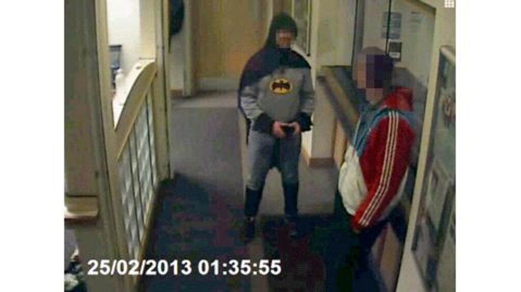 A man dressed as Batman walked into a police station and handed over a wanted man to officers.
