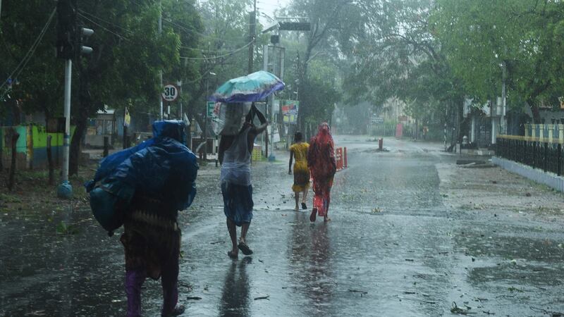 Residents walk along a street to a shelter in Digha, West Bengal. Photograph: Dibyangshu Sarkar/AFP via Getty Images