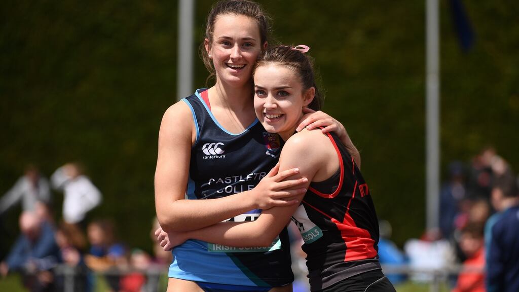 Ciara Neville of Castletroy College, Co Limerick, embraces Aoife Lynch of Luttrellstown, Co Dublin, after winning the Senior Girl’s 100m at Tullamore. Photograph: Sam Barnes/Sportsfile