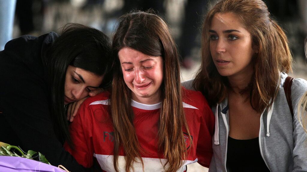 Mourners cry next to a coffin prior the funeral for victims of the earthquake that levelled the town in Amatrice. Photograph: Max Rossi/Reuters