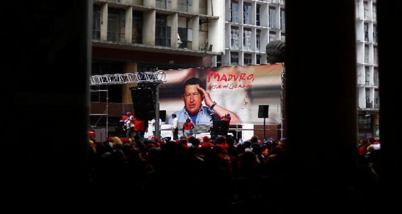 Supporters of Venezuela's late president Hugo Chavez prepare a stage, from which they expect acting president Nicolas Maduro to launch his campaign for president, outside the national election board in Caracas, today.