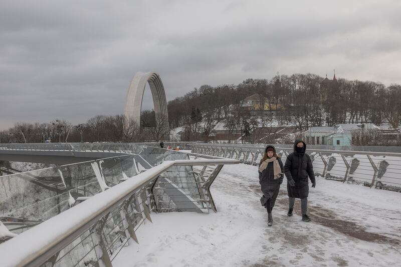 People walk in the snow on a pedestrian bridge in downtown Kyiv on Monday. Photograph: Roman Pilipey/AFP via Getty