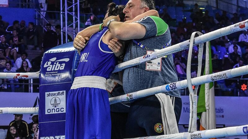Kellie Harrington celebrates with coaches Zaur Antia and Dmitry Dimitru. Photograph: AIBA