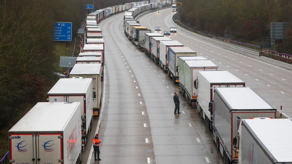 Truck drivers stand  near parked trucks on the M20 motorway  in the UK. Photograph: Chris Ratcliffe/ Bloomberg