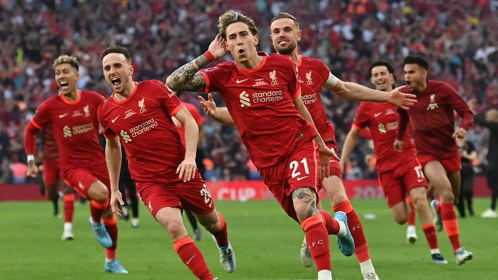 Liverpool’s Greek defender Kostas Tsimikas celebrates with his team mates after scoring the winning penalty. Photograph: Getty Images