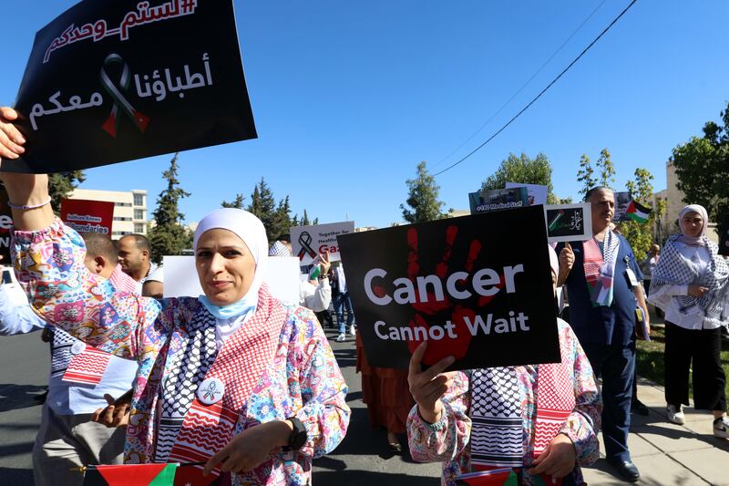Doctors and medical personnel of the al-Hussein cancer hospital in Amman, Jordan, stage a demonstration in solidarity with Palestinian civilians, hospitals and cancer patients in Gaza. Photograph: Mohammad Ali/EPA-EFE