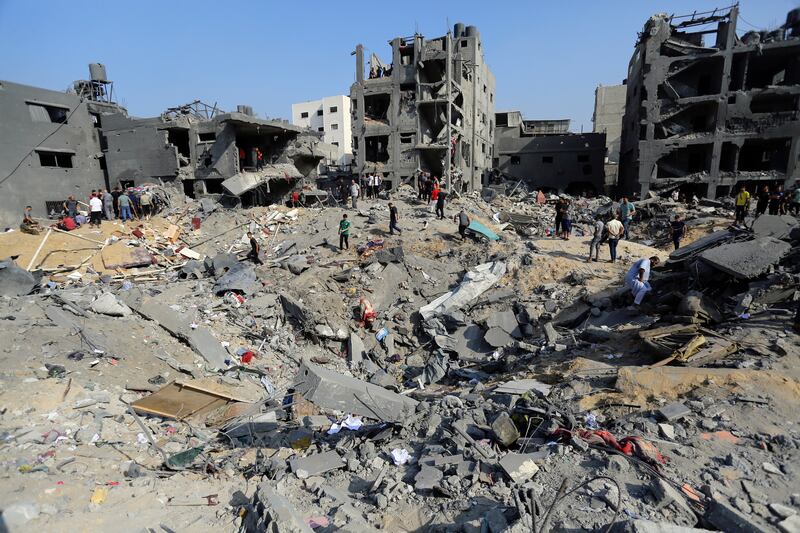 Palestinians wander among debris of buildings that were targeted by Israeli airstrikes in Jabaliya refugee camp, northern Gaza. Photograph: AP
