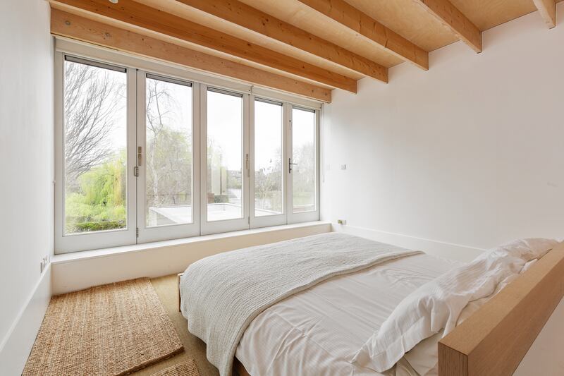 Upstairs bedroom has bifold doors and views of Blessingon Basin gardens