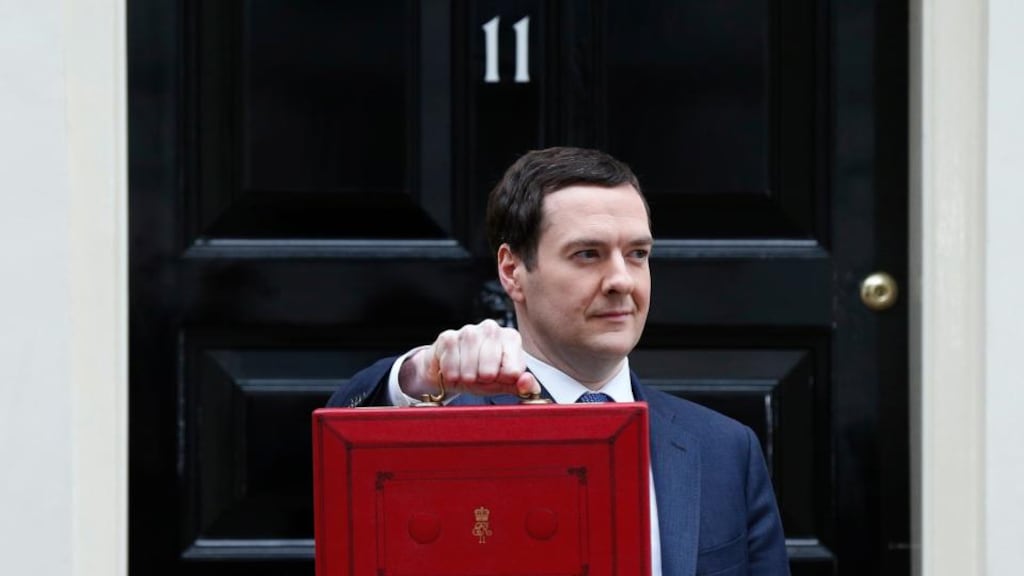 Britain’s Chancellor of the Exchequer, George Osborne, holds up his budget case for the cameras as he stands outside number 11 Downing Street. Photograph: Suzanne Plunkett / Reuters