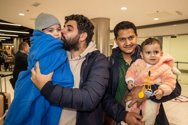 Khalid El-Astal with his children, Ali aged four and Sara aged one, and their uncle, El-Astal's brother-in-law Mohammed Jendia at Dublin Airport. Photograph: Tom Honan for The Irish Times