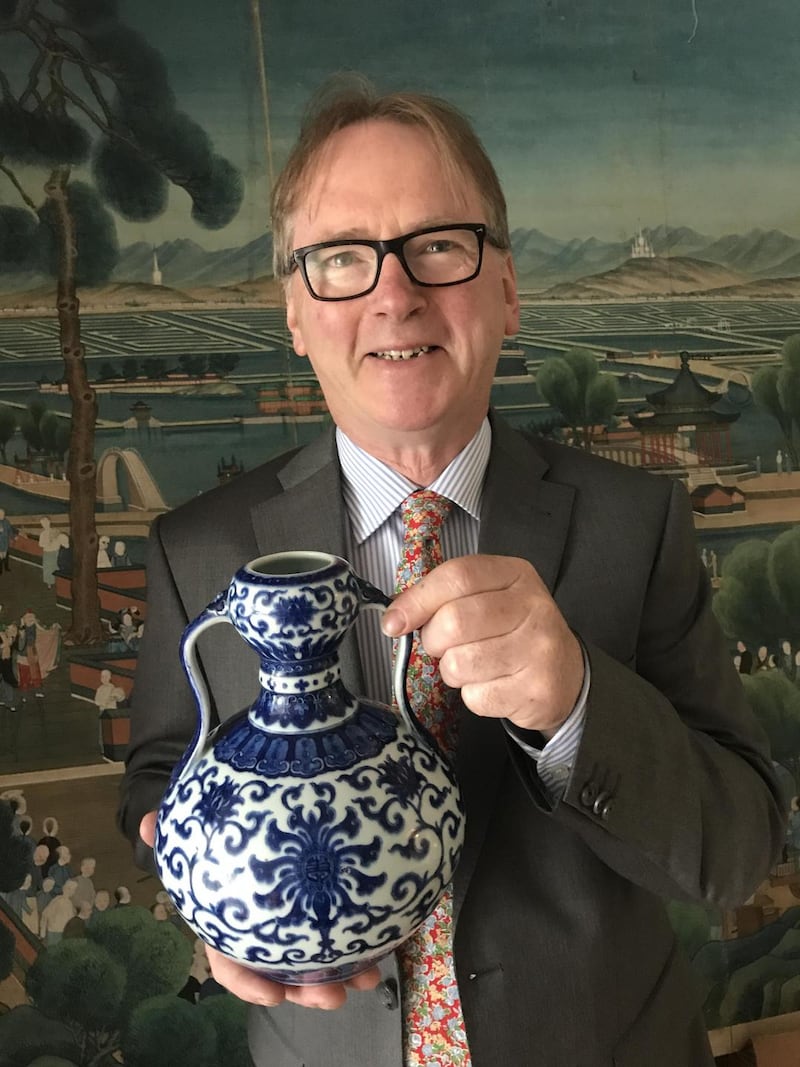 Auctioneer Michael Sheppard holding the antique Chinese porcelain vase that sold for €740,000 – the highest price ever paid for a piece of decorative art at auction in Ireland