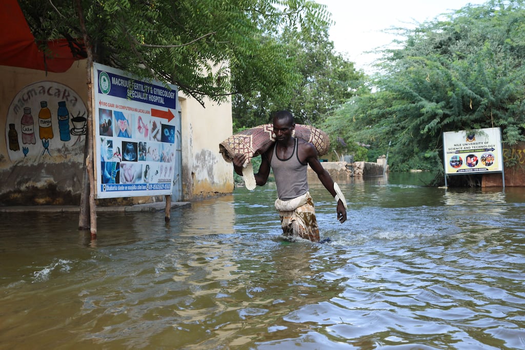 A man walks through floodwater in Beledweyne, central Somalia, where the Shabelle River burst its banks, forcing thousands of people to abandon their homes. Photograph: Hasan Ali Elmi/AFP via Getty Images