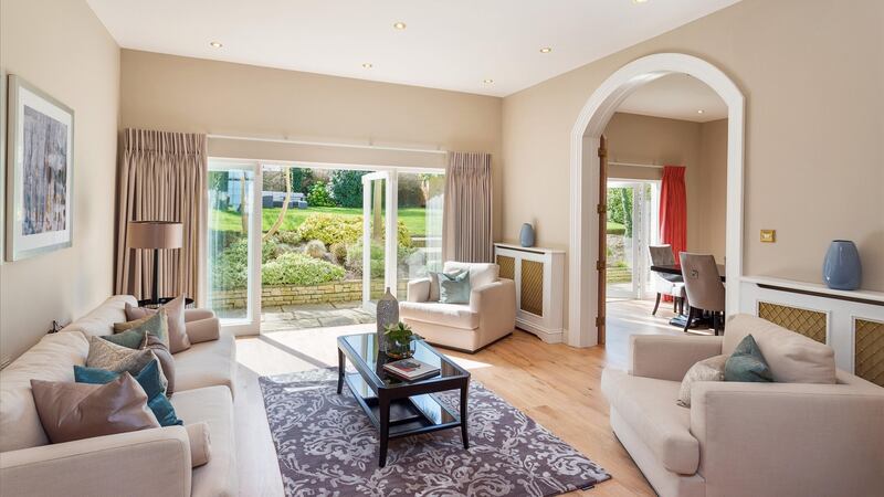 A large family room at the back of the house is one of three separate but linked rooms which all have French doors opening into the back garden