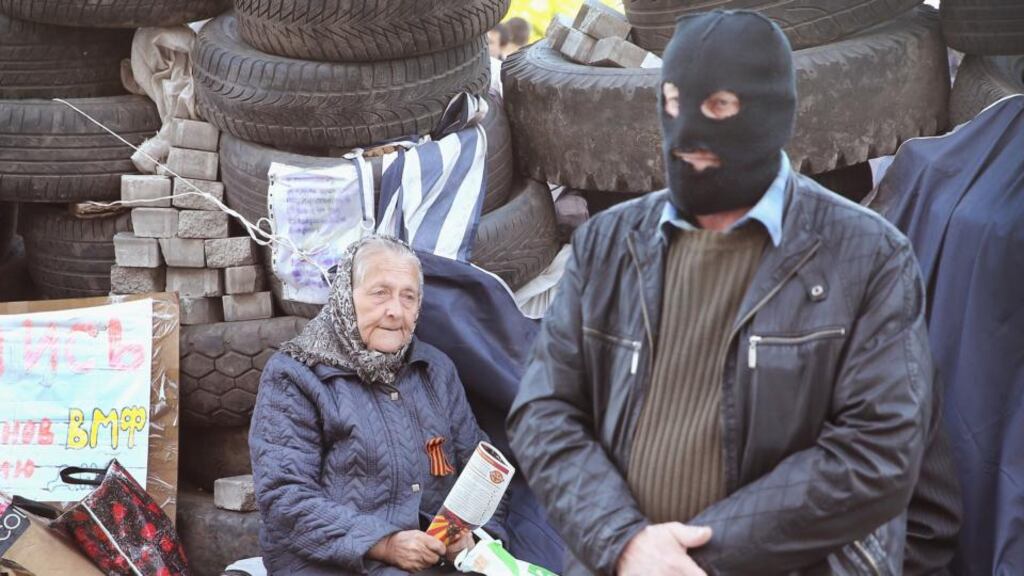 A pro-Russian separatist stands guard inside a barricade constructed around the Donetsk regional administration building following its recent takeover by separatists. Photograph: Scott Olson/Getty Images