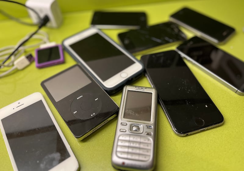 Old iPhones and mobile phones found in a drawer. Photograph: Bryan O’Brien
