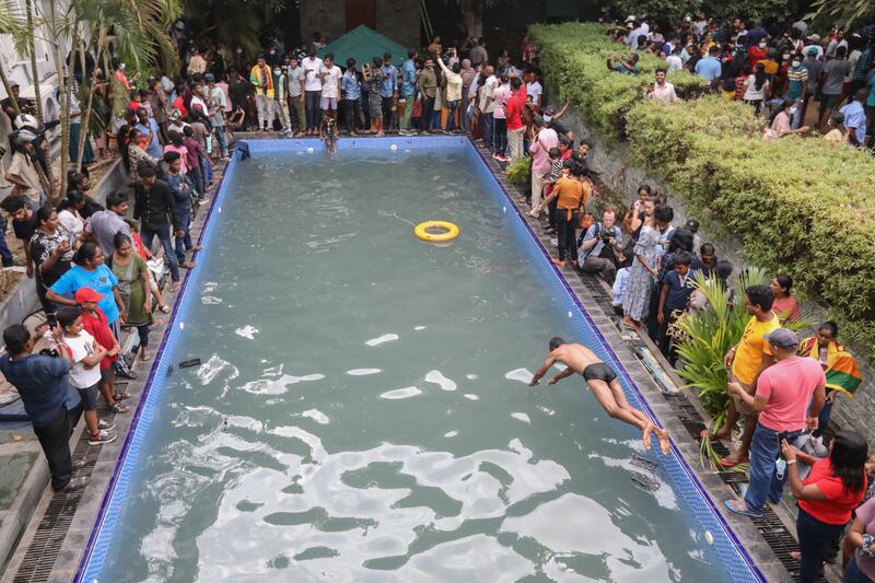 People take a look at and a dip in a swimming pool at the president's palace in Colombo, Sri Lanka. Photograph: EPA-EFE