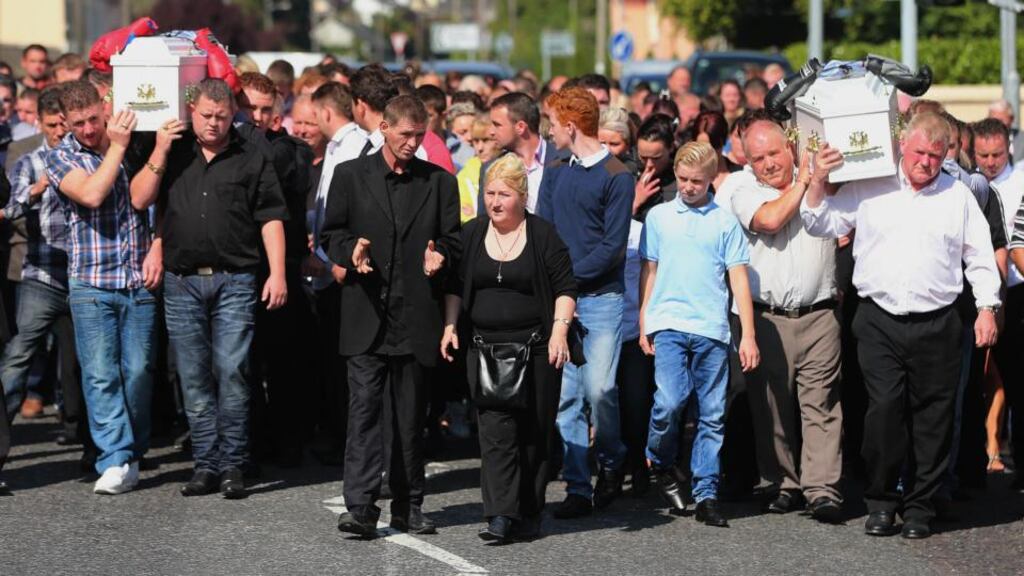 Parents Thomas and Helen O’Driscoll (centre) walk in front of the cortege as the funeral of twin boys Thomas and Patrick O’Driscoll who died in a suspected murder suicide with their older sibling Jonathan takes place at the Holy Cross Parish Church in Charleville. Photograph: Niall Carson/PA