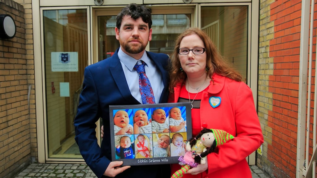 John and Louise Wills with photos of their baby daughter Eibhlín Wills who died aged 12 days old from the common cold sore virus. Photograph: Gareth Chaney/Collins