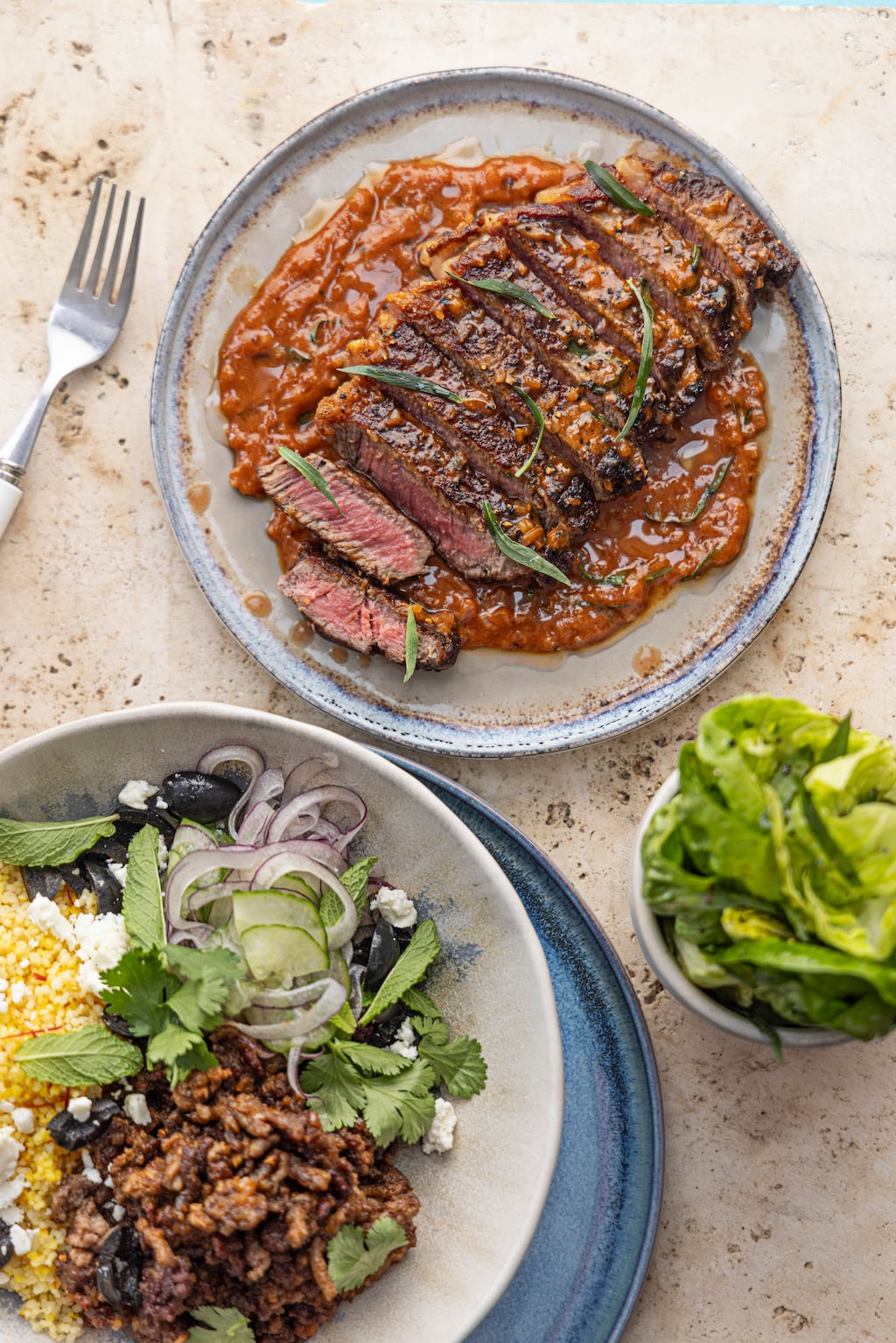 Stir-fried spiced lamb with cous cous, yoghurt, olives and mint. Photograph: Harry Weir Photography.