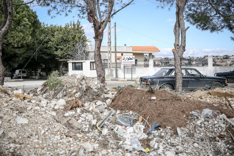 A sign for the emergency department at Bint Jbeil government hospital stands behind the rubble of a destroyed building. Photograph: Sally Hayden
