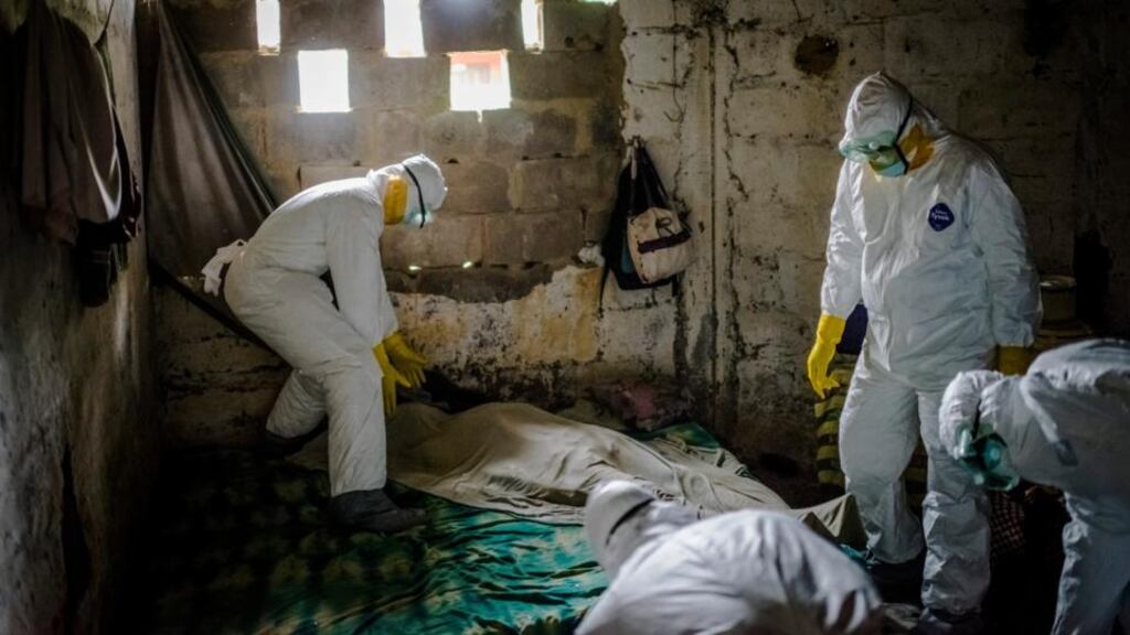 Members of an Ebola burial team collect the body of a suspected Ebola victim from a home in Monrovia, Liberia. The WHO said the number of afflicted patients was increasing exponentially and that nearly all the country has confirmed cases and that all new treatment facilities are overwhelmed. Photograph: Daniel Berehulak/The New York Times