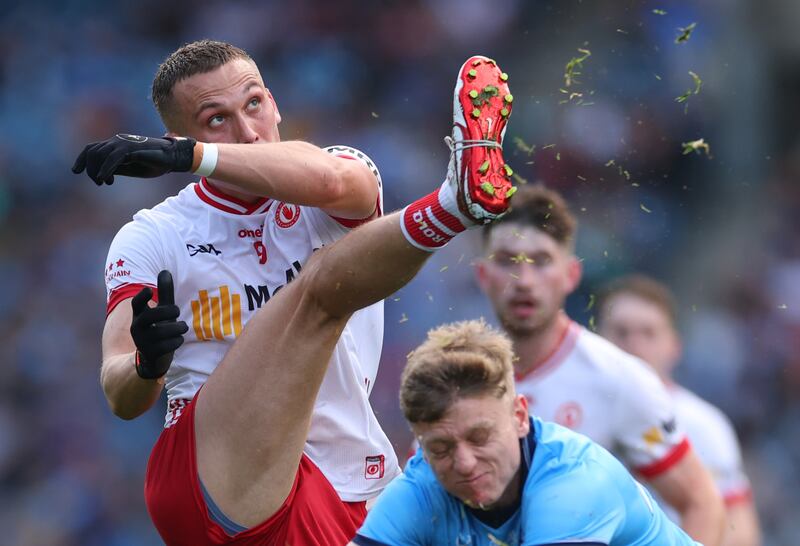 Tyrone's Conn Kilpatrick gets a kick away despite the best effort of Dublin's Cian Murphy. Photograph: James Crombie/Inpho