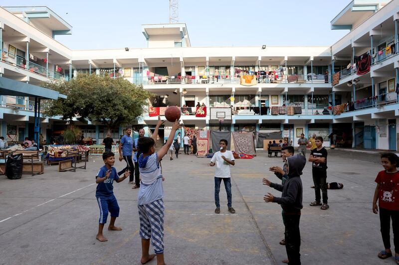 Palestinian children play in the yard of a school, in the Rafah refugee camp, in the southern of Gaza Strip on Sunday, as fighting between Israel and Hamas continues for the eighth consecutive day in the Gaza strip. Photograph: AFP