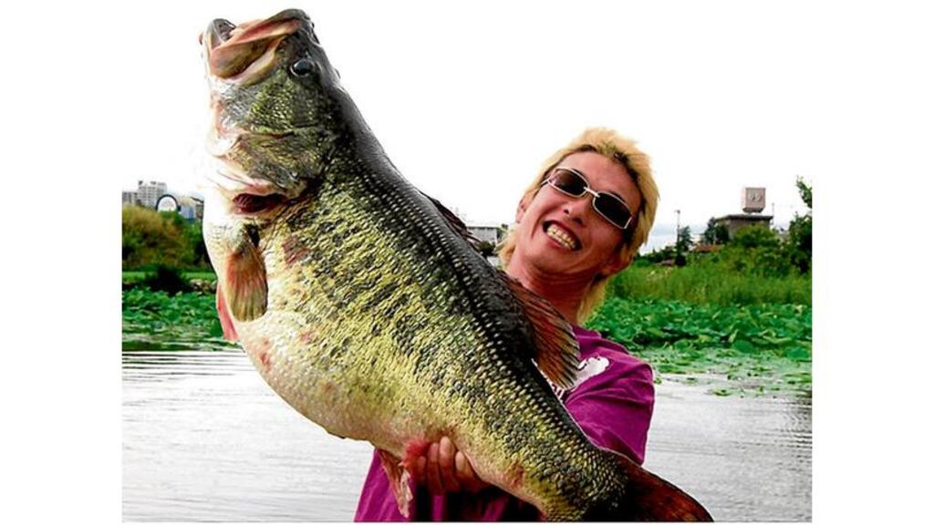 It's official: Manabu Kurita of Aichi, Japan, proudly holds aloft his world record largemouth bass. Photo courtesy of IGFA.org