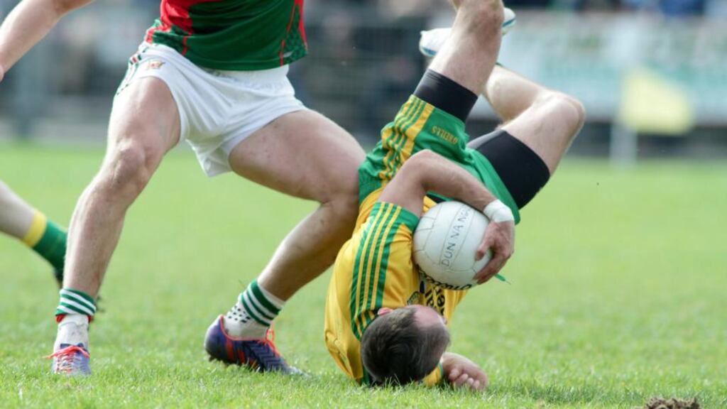 Donegal’s Karl Lacey takes a tumble during robust league draw with Mayo. Photo: Mike Shaughnessy/Inpho