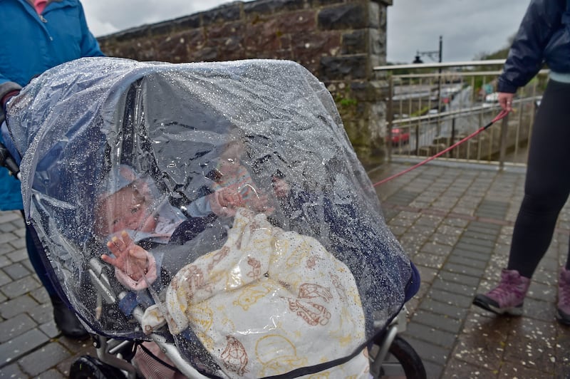 Under cover from the showers in Newport are Regan and Brook. Photograph: Conor McKeown