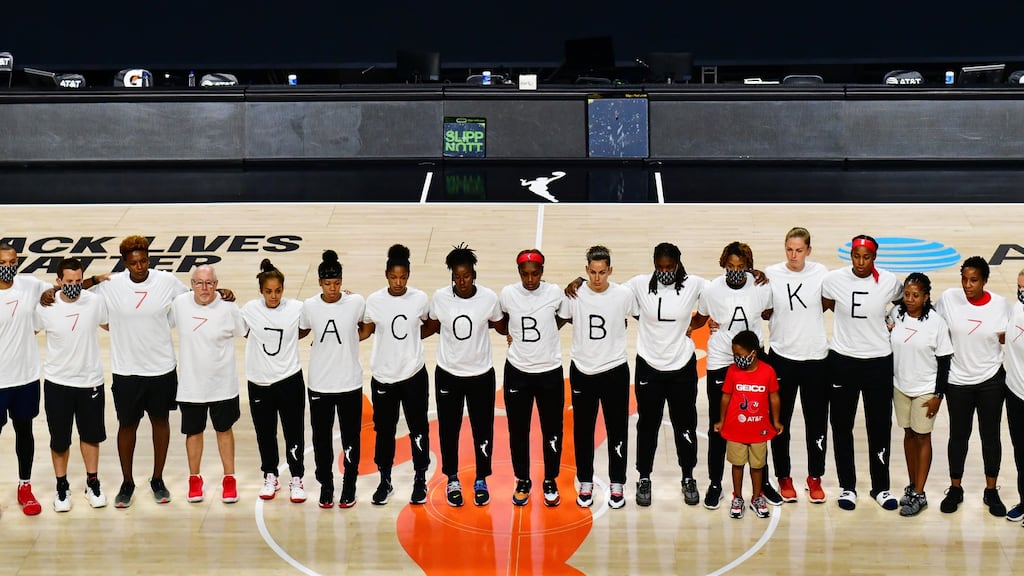 Washington Mystics players  each wear white T-shirts with seven bullets on the back protesting the shooting of Jacob Blake in Kenosha, Wisconsin. Photograph: Julio Aguilar/Getty Images