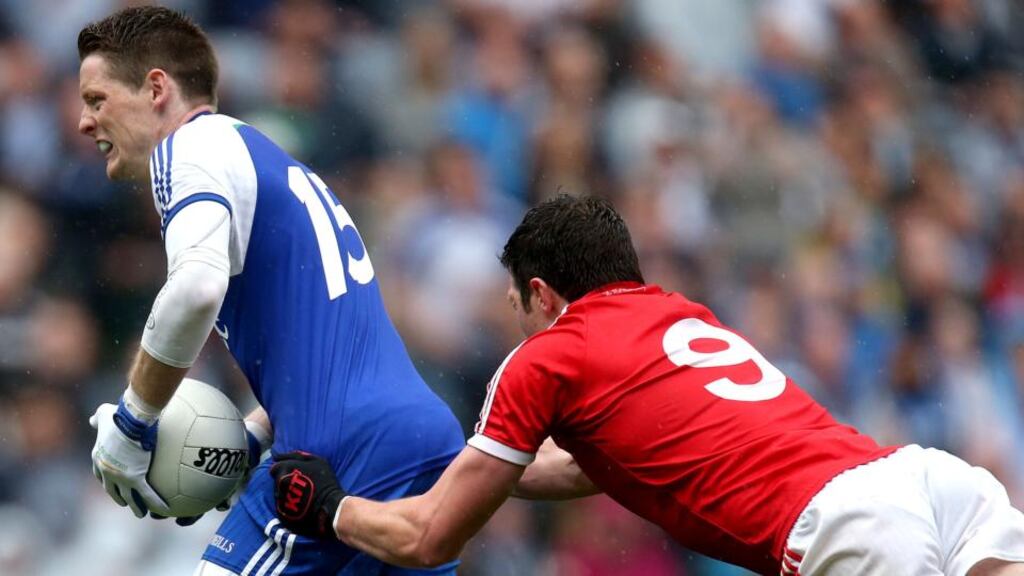 Monaghan’s Conor McManus is dragged down by Tyrone’s Seán Cavanagh during the All-Ireland football quarter-final at Croke Park. Photograph: Ryan Byrne/Inpho