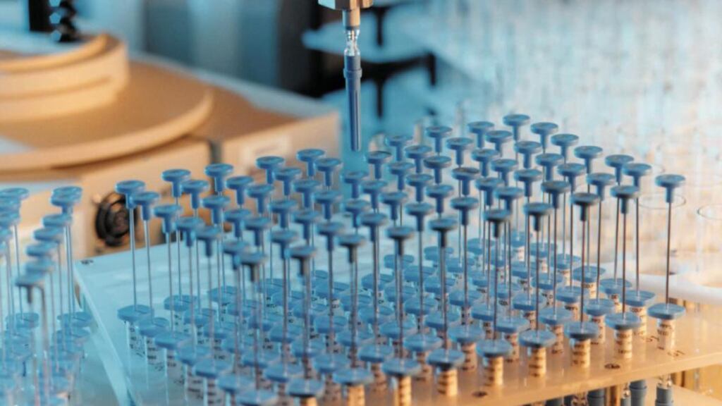 A robotic arm works above a tray of samples at an AstraZenenca Plc facility Photograph: NewsCast/AstraZeneca Plc via Bloomberg