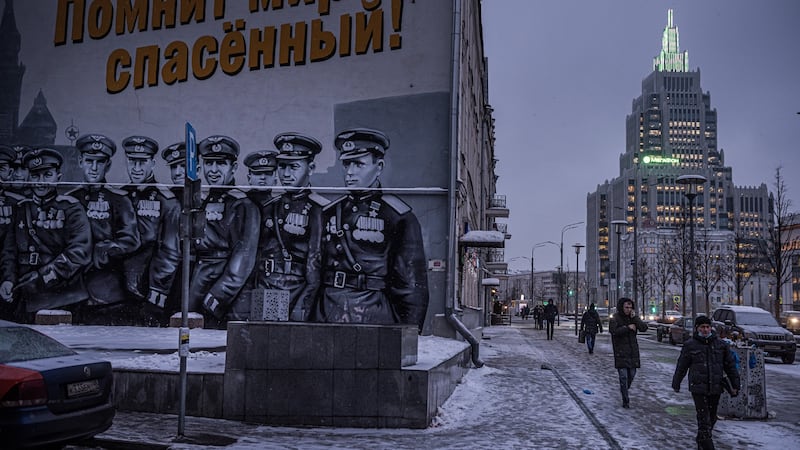 A patriotic mural in Moscow shows Soviet pilots from the second World War, based on a photograph of the Victory Parade in 1945. The sign in Russian reads, The saved world remembers you! Photograph: Sergey Ponomarev/ The New York Times