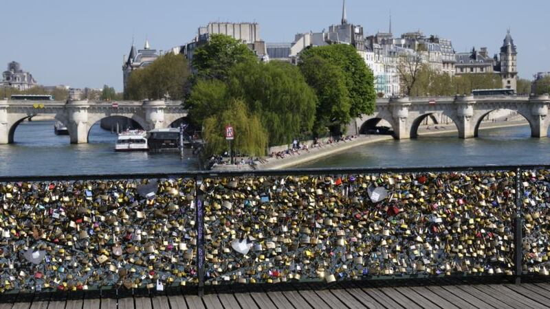 Lovers are asked to take a photo of themselves rather than leave a lock on the Pont des Arts in Paris. Photograph: Getty