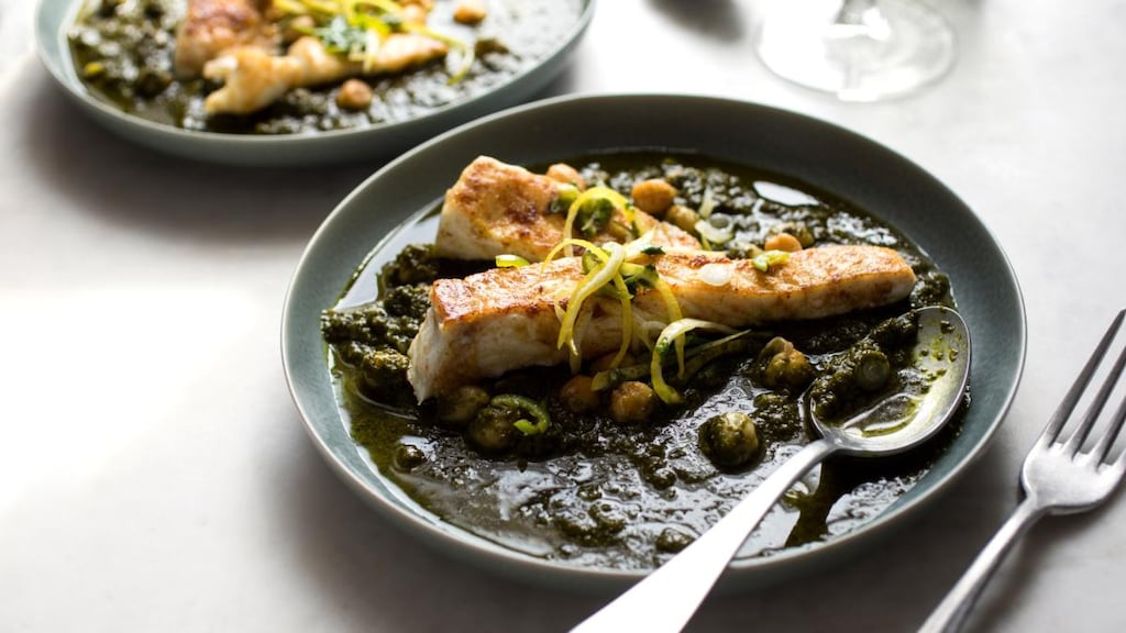 Yotam Ottolenghi’s spiced halibut with spinach and chickpea stew. Photograph: Andrew Scrivani/New York Times