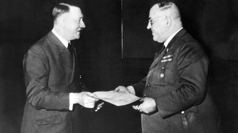 Adolf Hitler awarding his personal physician, Dr Theodor Morell, the Knight’s Cross of the War Merit Cross in Berlin, 1944