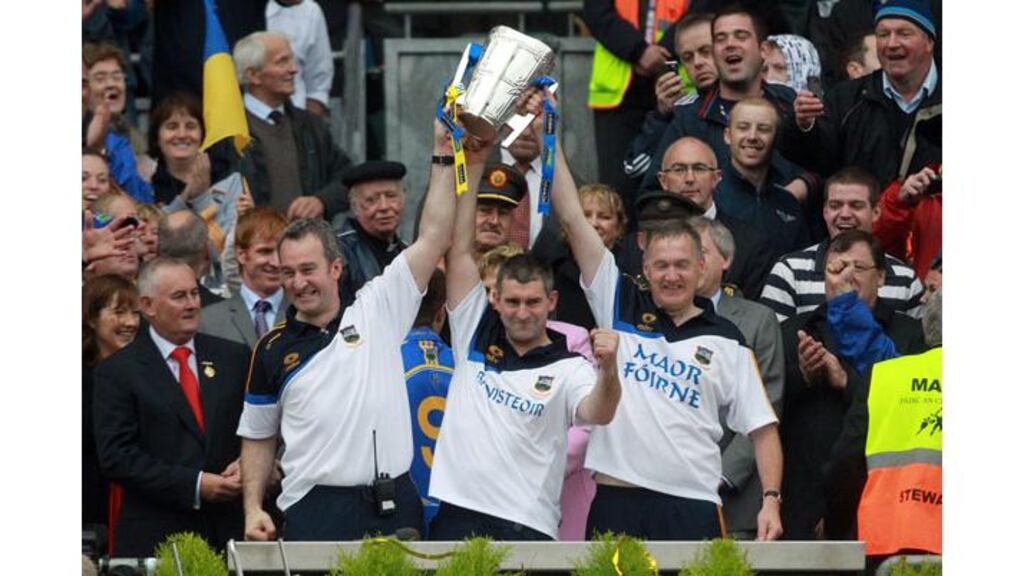 Liam Sheedy (centre), Michael Ryan (left) and Eamon O'Shea (right) lift the Liam MacCarthy Cup last month. All three have stepped down from their roles with Tipperary. Photograph: Donall Farmer/Inpho