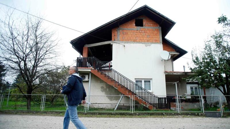 A man walks by the house in   in Sisak, central Croatia,  where British aid worker David Haines lived with his wife and daughter. Photograph: Antonio Bronic/Reuters