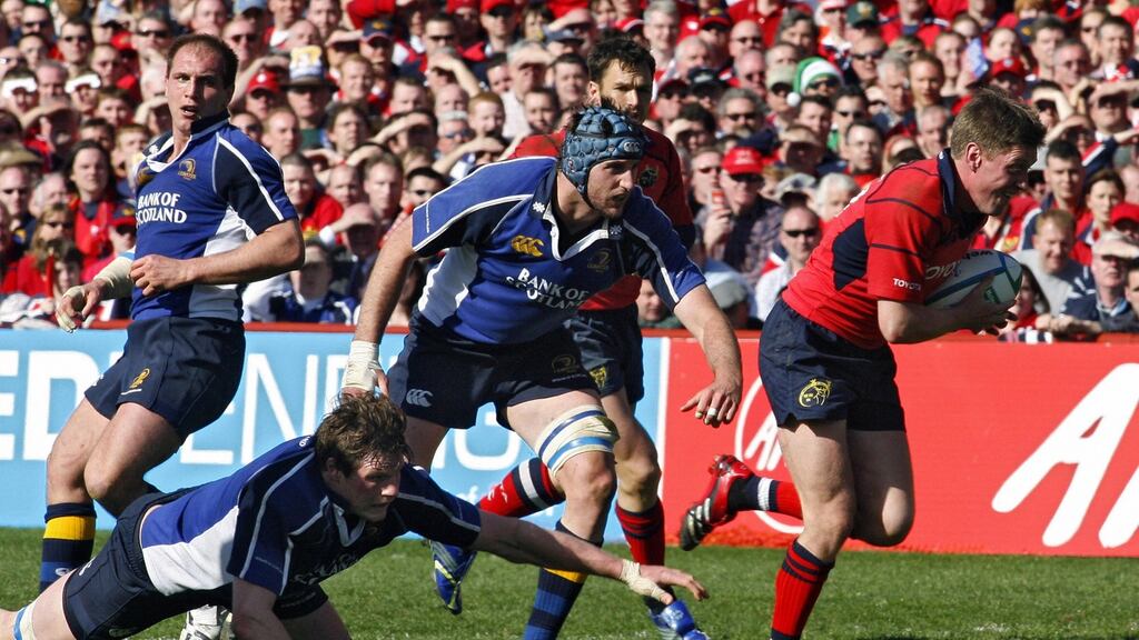 Munster’s Ronan O’Gara goes by Bryce Williams and Malcolm O’Kelly of Leinster during their Heineken Cup semi-final in 2006. Photograph: Getty Images/Inpho