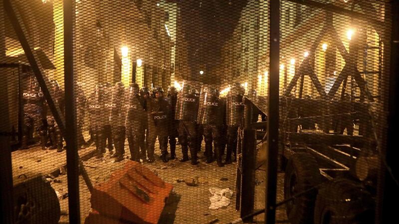Lebanese riot police guard an access to the parliament during clashes with anti-government protesters in Beirut on Tuesday night. Photograph: Getty