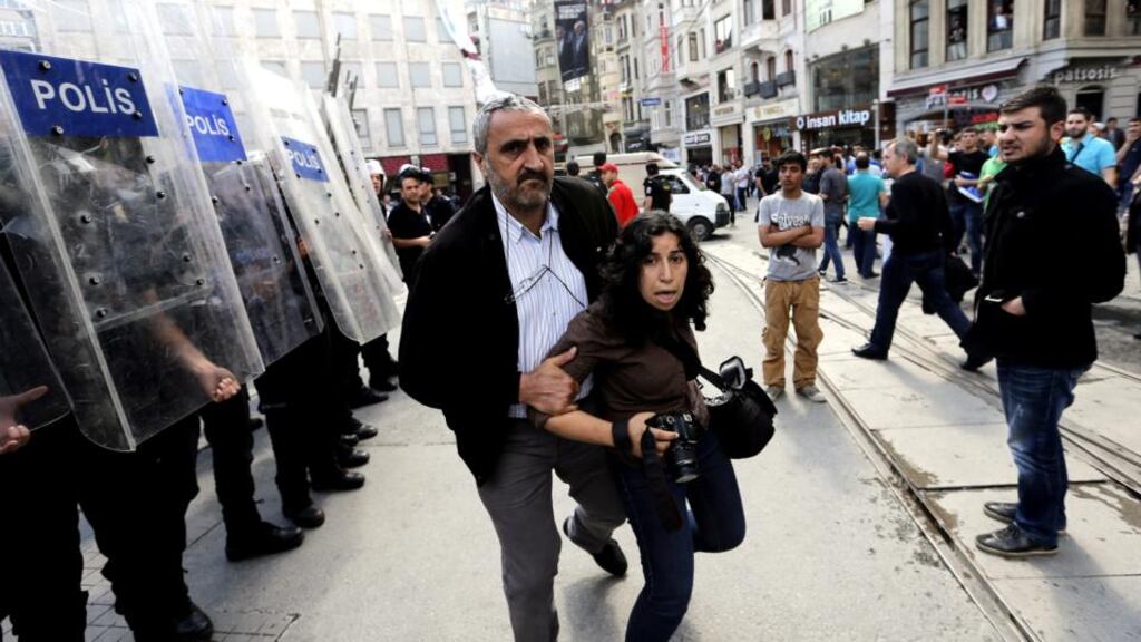 A Turkish plainclothes policeman detains a journalist during a demonstration on the first anniversary of the Gezi Park protests near Taksim Square in Istanbul. Photograph: Sedat Sund/EPA